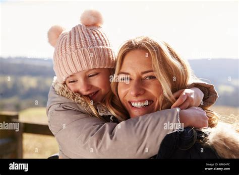 Portrait of mother and daughter embracing in the countryside Stock ...