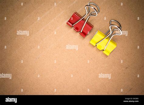 colored metal paper clips on a paperboard surface Stock Photo - Alamy