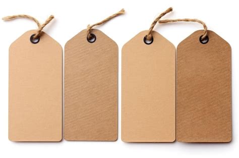 Premium Photo | Brown paper tags with string on white background