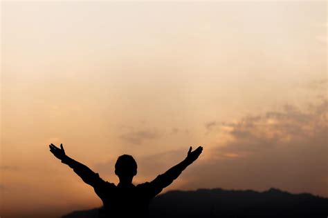 silhouette   man lift hands   prayer  sunset concept