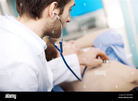 doctor examining patients heartbeat   stethoscope stock photo alamy
