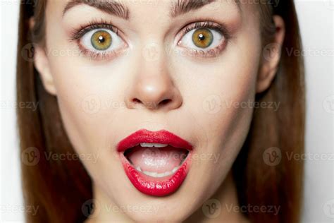 Close-up woman face with open mouth and surprised eyes attractive