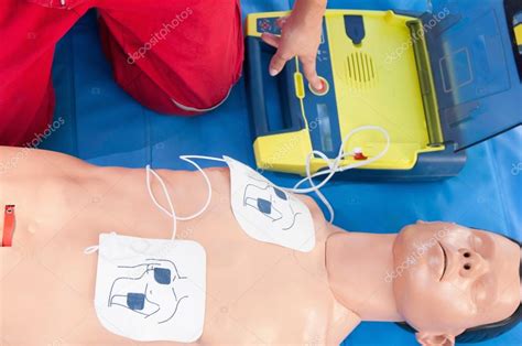 Paramedic activating portable defibrillator Stock Photo by ©microgen ...