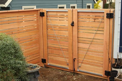 a wooden fence that is next to a potted plant