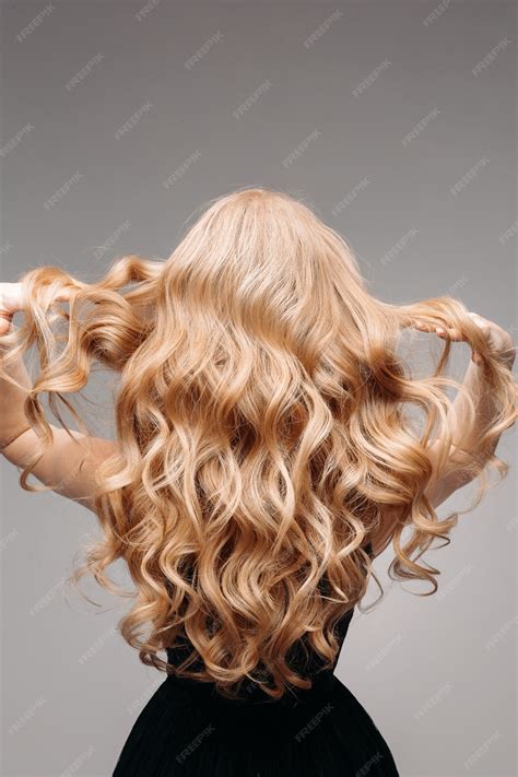 Premium Photo | Stunning woman with perfect wavy blonde hair.