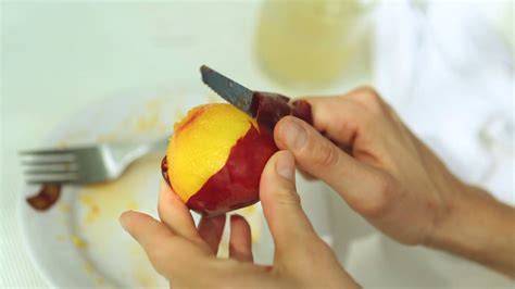 close   womans hands cutting peach stock footage sbv