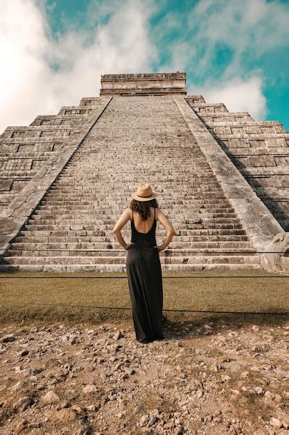 Premium Photo | Woman wearing hat and black dress (back view, unrecognized) in front of the ...