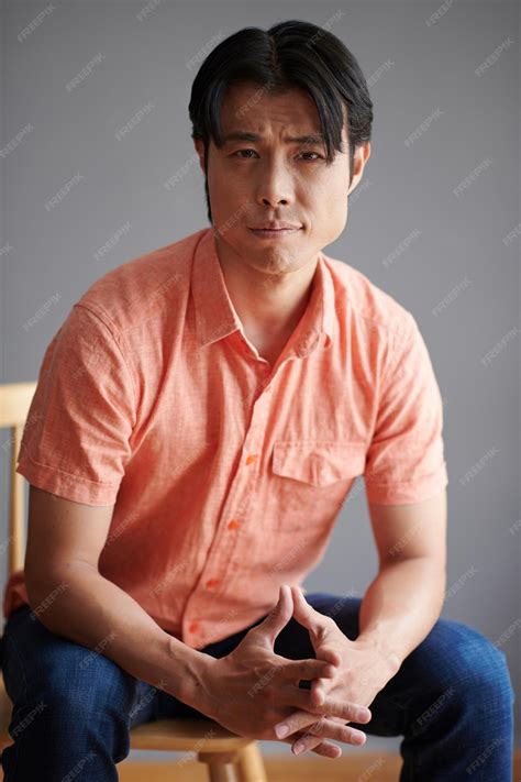 a guy sitting in a chair 8