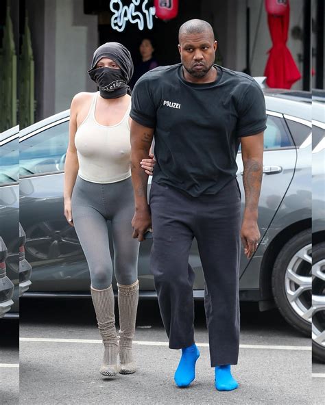 Just Jared | Kanye West went shoeless in blue socks and wore a shirt