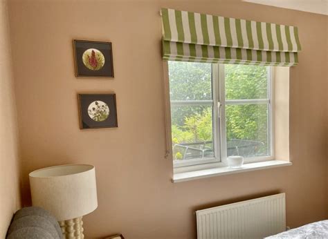 Green and white striped roman blinds against Setting Plaster walls ...