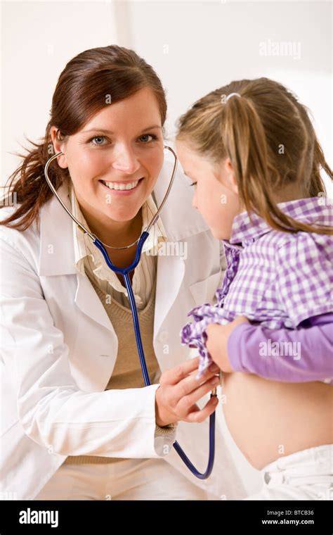 Female doctor examining child with stethoscope at medical office Stock ...