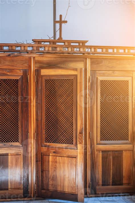 wooden catholic confessional with open door inside interior of an