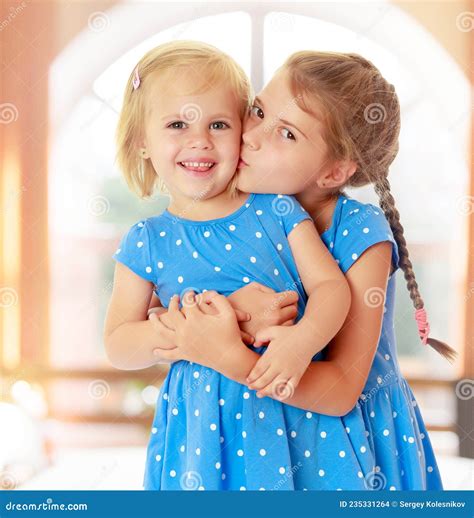 Little sisters kiss stock photo. Image of brother, siblings - 235331264