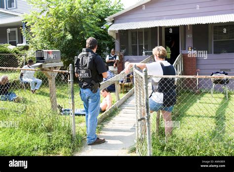 ATF agent and female police officer keeps watch over handcuffed female ...