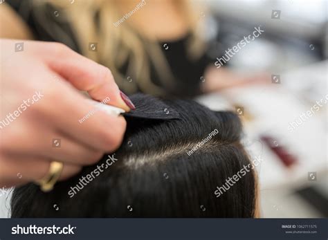 hairdresser hand putting hair color sample stock photo