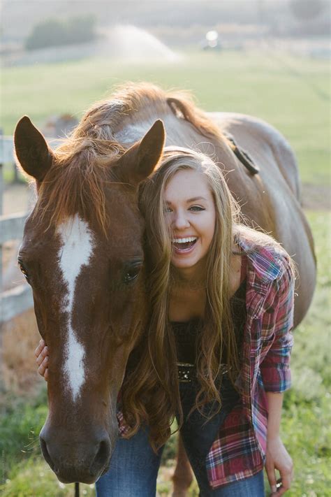 "Smiling Teen Girl Standing By Horse In Pasture" by Stocksy Contributor