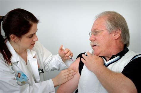 picture middle aged man receiving intramuscular immunization
