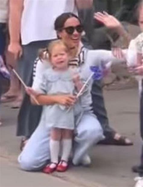 Meghan and Princess Lilibet of Sussex watching a July 4 parade in