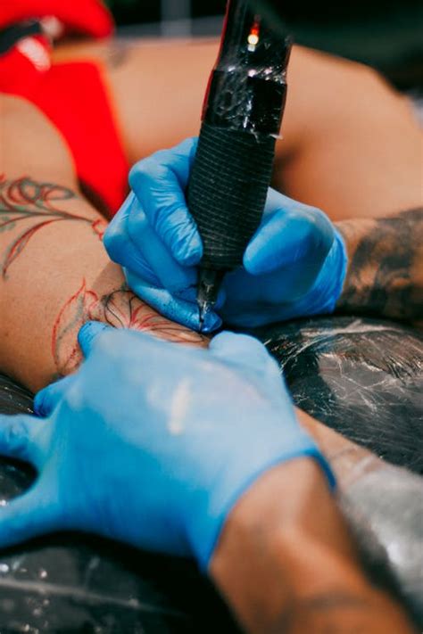 close   tattoo artist inking  design  stock photo