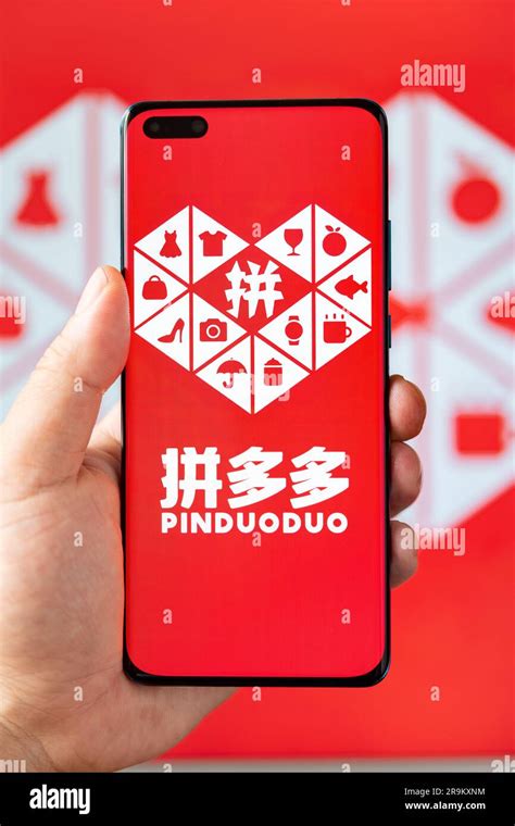 zhongshan china june man holding  mobile  pinduoduo logo