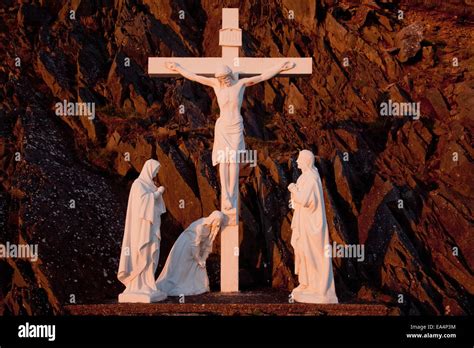 Statues of Jesus Christ on the cross and followers at the foot of the cross; County Kerry ...