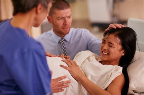 Premium Photo | Woman giving birth to child in hospital