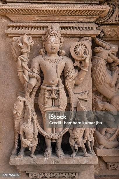 artistic carvings  hindu deities  ancient temple wall  daylight