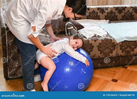 Gym Ball and Baby. Gymnastics Baby. Woman Doing Exercises with a Child for His Development ...