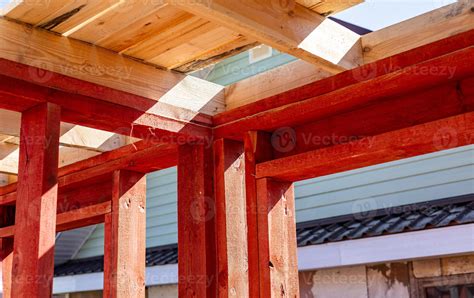 Under-construction residential wooden frame home located near a forest