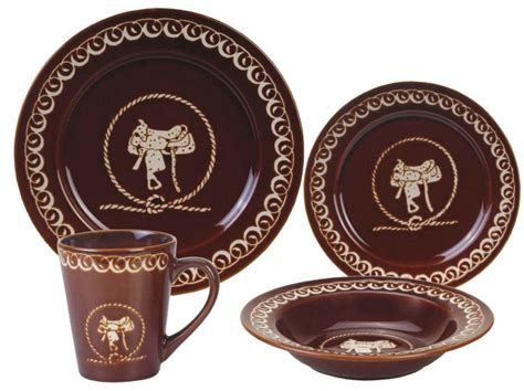 a brown and gold dinnerware set with an elephant design on the front, two cups and saucers