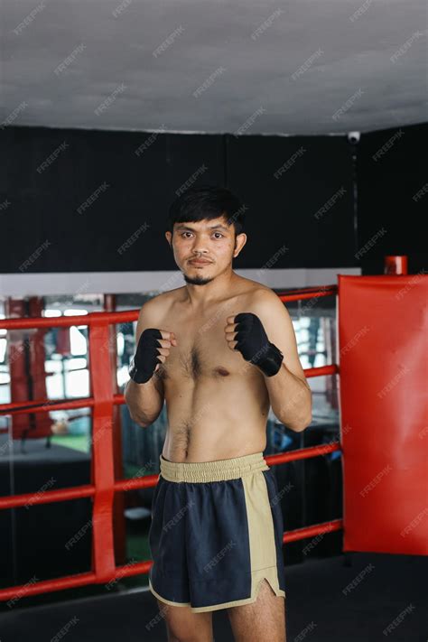 Premium Photo | Confident Asian Muay Thai Man Clenched Fist And Showing