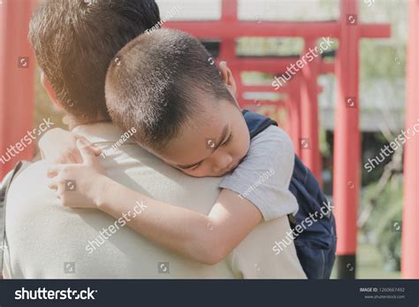father carries  son  shoulders  images stock