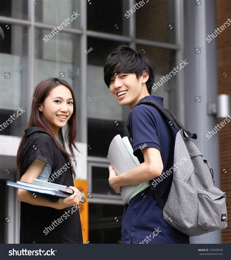 Couple College Student Sitting Holding Laptop Stock Photo 129435818