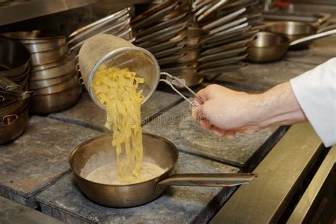 Chef is cooking pasta stock image. Image of catering - 69590649