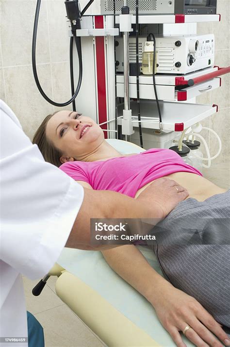 Doctor Testing Stomach Of Young Woman Stock Photo - Download Image Now ...