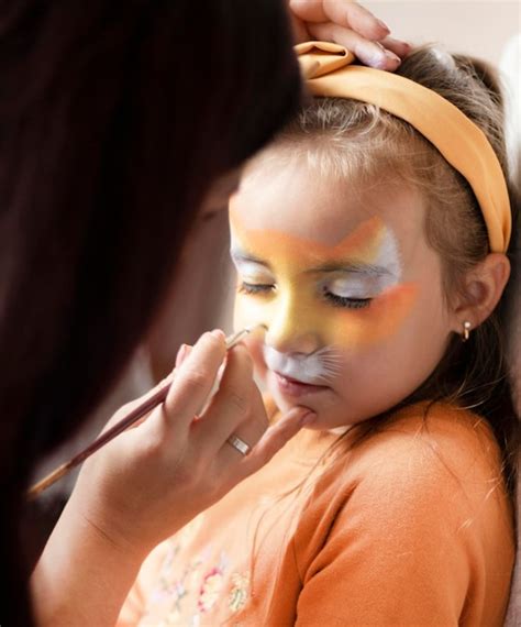 Premium Photo | Cute makeup little tiger girl getting face painting ...