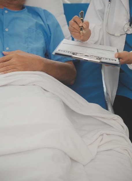 Premium Photo | Close up of female doctor using stethoscope putting ...