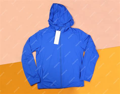 Premium Photo | Blue hood wind jacket on passtel background