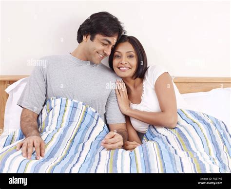 Indian husband wife relaxing at bedroom hi-res stock photography and