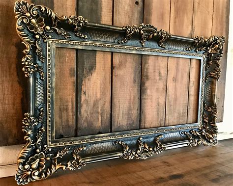 large ornate black wall frame  gold highlighting huge vintage