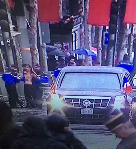 Topless Female Protesters Run Towards Trump's Motorcade in Paris (PHOTO