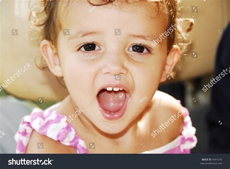 Cute Baby Girl Sticking Her Tongue Out And Showing Her Baby Teeth ...