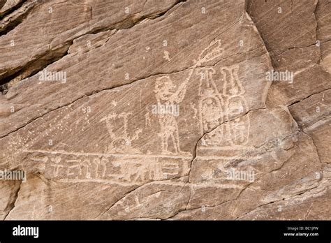 Rock-art in the Wadi Hammamat showing fan-bearer and plumed cartouches, Eastern Desert of Egypt ...