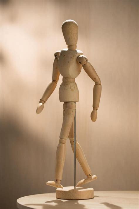 artist wooden mannequin stands poised ready  inspire creators