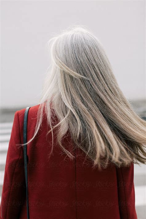 "Back View Of Mature Woman With Grey Long Hair In The City." by Stocksy