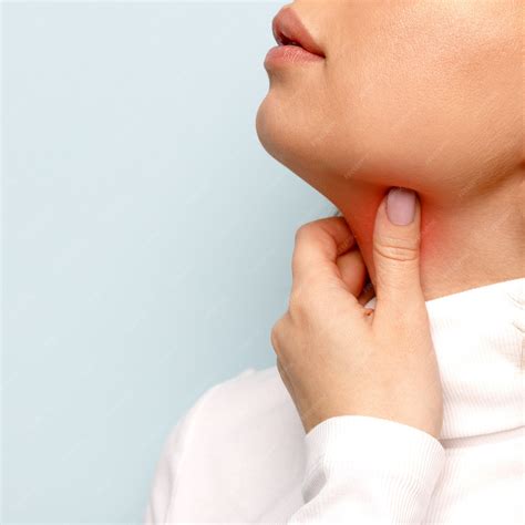 Premium Photo | Woman touches fingers of sore throat. Thyroid gland
