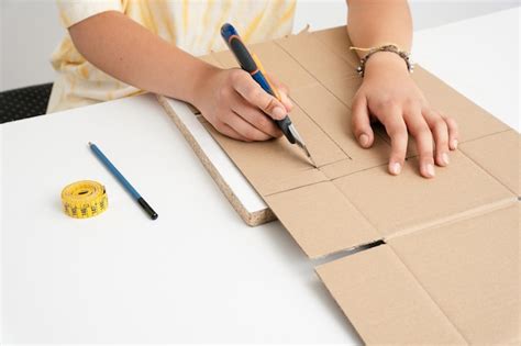 premium photo womans hands  crafts cutting cardboard   cutter