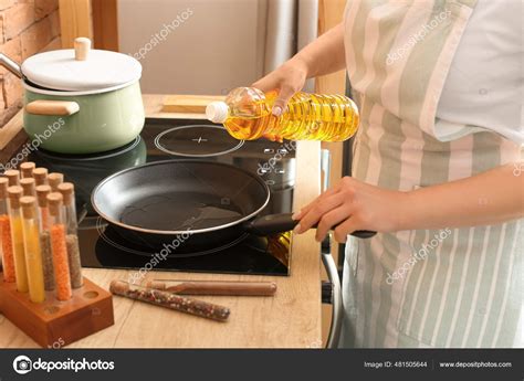 Woman Pouring Sunflower Oil Frying Pan Kitchen Stock Photo by ©serezniy 481505644