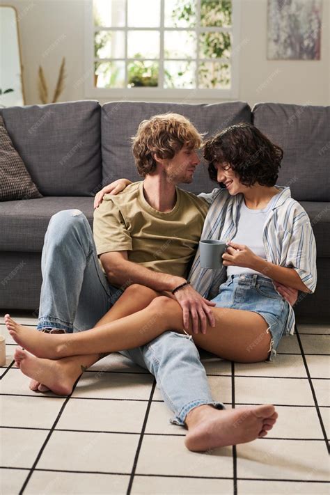Premium Photo | Happy young barefooted couple in casualwear relaxing on