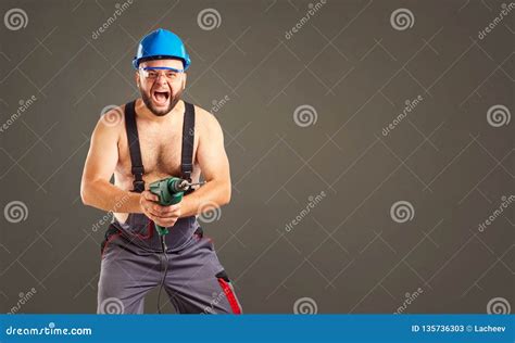 Funny Builder with a Drill in His Hands. Stock Image - Image of occupation, workman: 135736303